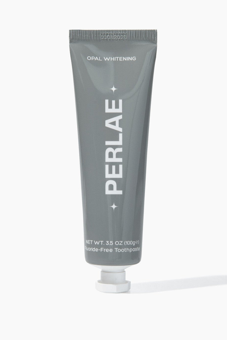 Gray toothpaste tube with 'PERLAE' branding on a white background