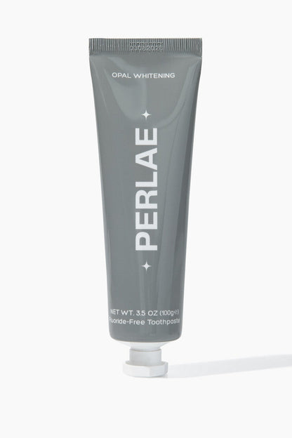 Gray toothpaste tube with 'PERLAE' branding on a white background