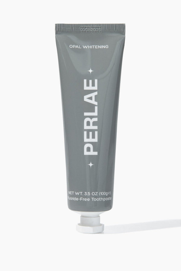 Gray toothpaste tube with 'PERLAE' branding on a white background