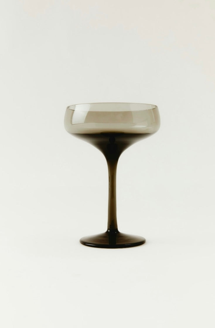 Cocktail glass with a dark base and light top on a white background